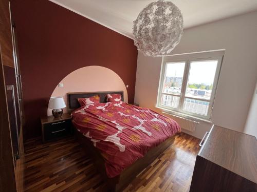 a bedroom with a bed and a large window at Condo Casa Di Olivia in Maribor