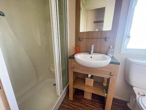 a bathroom with a sink and a shower at Lovely Caravan With Decking Nearby Scratby Beach In Norfolk Ref 50031j in Great Yarmouth