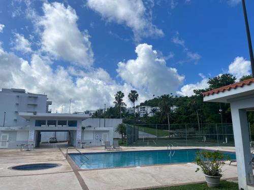 a swimming pool in front of a building at Relaxing Hillside Village Apartment in Rio Grande