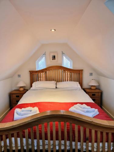 a bedroom with a large bed in a attic at Tigh Eilidh (The Cabin on the Hill) in Breakish