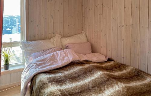 a bedroom with a bed with a blanket and a window at 3 Bedroom Stunning Home In Aurdal in Aurdal
