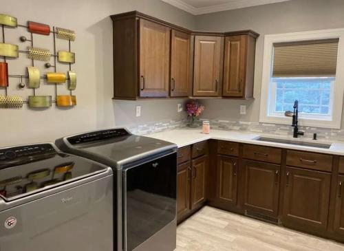 a kitchen with wooden cabinets and a stove top oven at Country home in Endwell