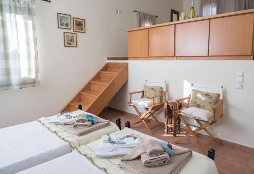 a living room with two chairs and a table at kouremenos beach house East in Angathiás