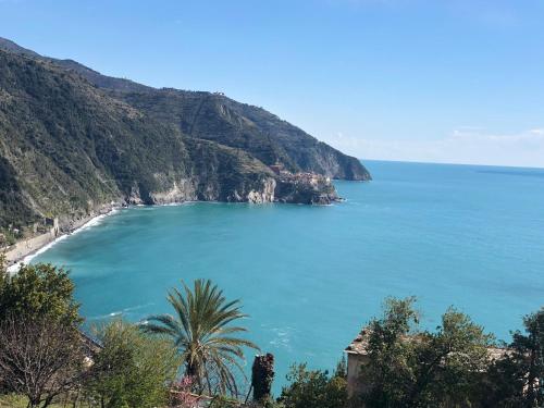 a view of a beach next to a mountain at My Place Your Place in Corniglia