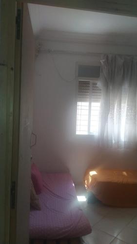 a bedroom with two beds and a window at appartement one room in Casablanca