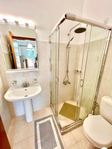 a bathroom with a shower and a sink and a toilet at SCALA APARTS & STUDIOS - Rhodes in Afantou