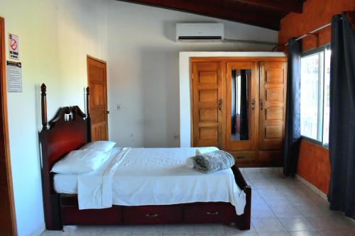 a bedroom with a bed and a wooden door at Casa Vieja Hotel y Restaurante in San Lorenzo
