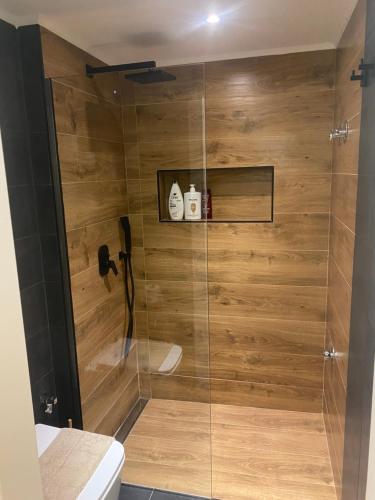 a shower with a glass door in a bathroom at Atelie home experience serres in Serres