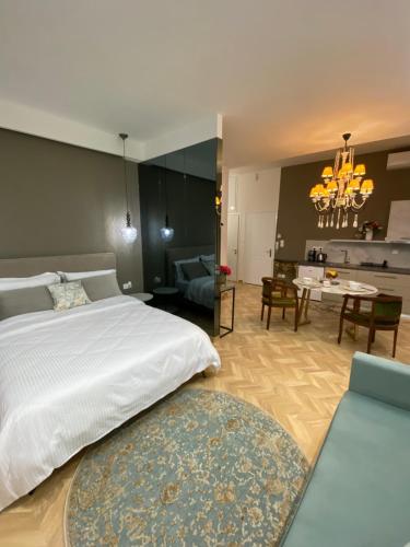 a bedroom with a large bed and a living room at Atelie home experience serres in Serres