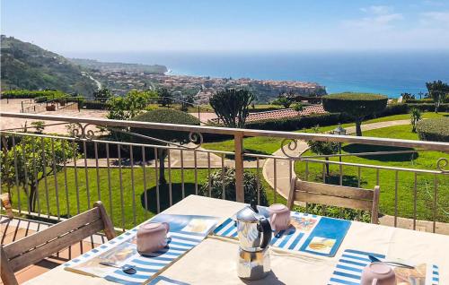 a table with a view of the ocean from a balcony at Casa Nardi in Parghelia
