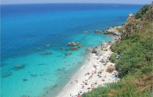 a group of people on a beach near the ocean at Casa Nardi in Parghelia