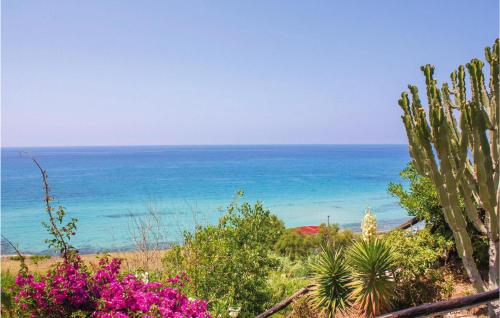 a view of the ocean from a beach with flowers at Casa Nardi in Parghelia