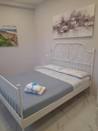 a white bed with towels on it in a room at Domus Pompeii Ruins in Pompei