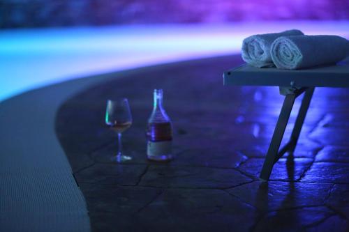 a table with a bottle of wine and a glass at Agri Resort Masusa in Aquara