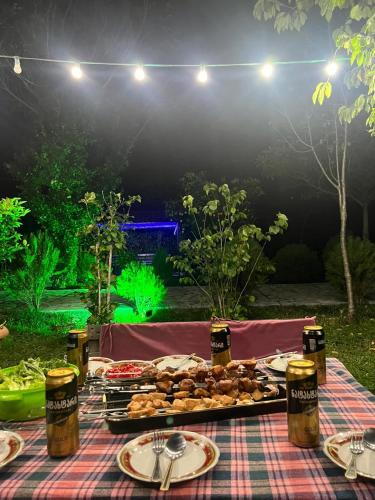 a picnic table with food on it with lights at Sweet Memories in Kutaisi