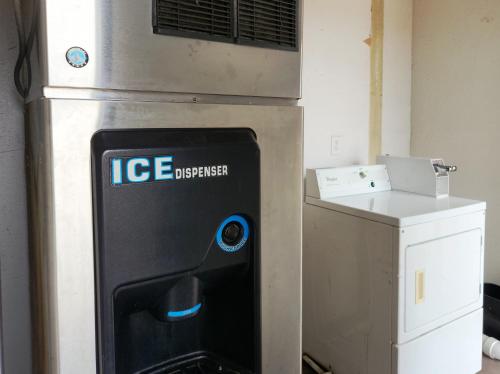 an ice dispenser is sitting next to a box at Express Inn Tomball in Tomball