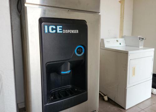 an ice dispenser is sitting next to a counter at Express Inn Tomball in Tomball