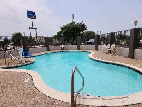 a large swimming pool with blue water at Express Inn Tomball in Tomball