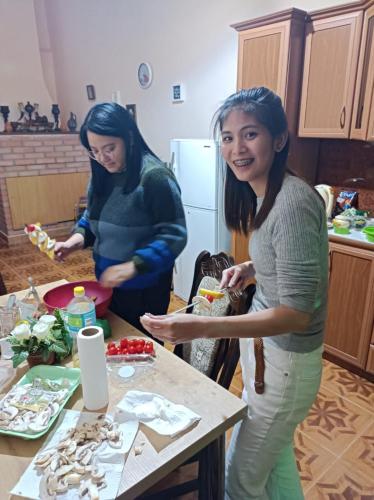 two women standing in a kitchen preparing food at Sweet Memories in Kutaisi