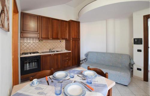 a kitchen with a table with plates and bowls on it at 1 Bedroom Beautiful Apartment In Ricadi in Ricadi