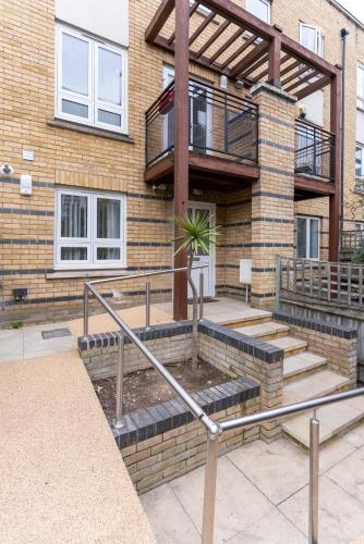 a brick building with stairs and a balcony at Canary Wharf O2 Deluxe Ensuite Rooms in London