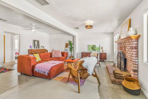 a living room with a couch and a fireplace at The Maude House in Twentynine Palms