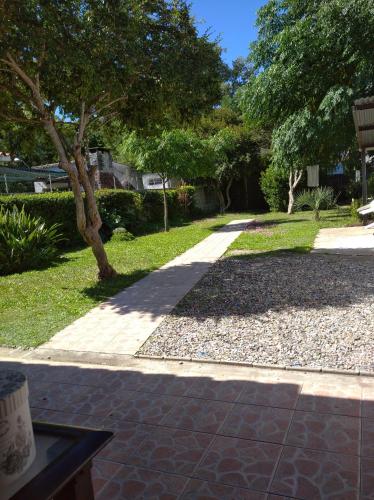 a walkway in a park with a tree and grass at Martin Fierro in La Floresta