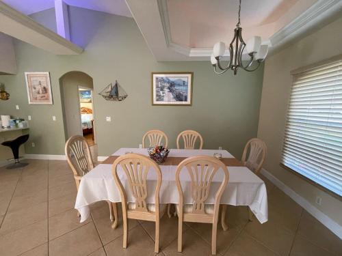 a dining room with a table and chairs at Pool Home in Englewood