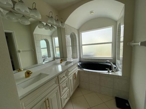 a bathroom with a sink and a large mirror at Pool Home in Englewood