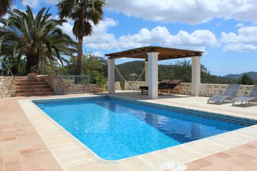 a swimming pool with a gazebo next to a villa at Villa Can Portmany in Sant Josep de sa Talaia