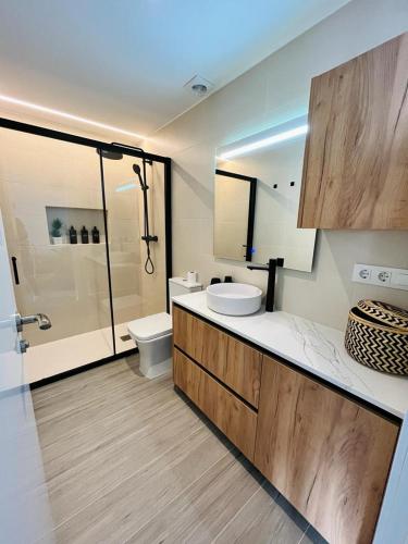 a bathroom with a toilet and a sink and a shower at El Piset 124 in Benissa