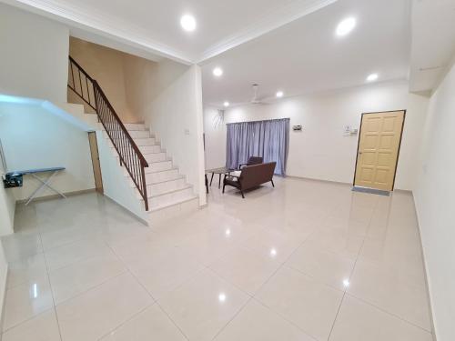 a living room with a staircase and a chair and a table at Air-home M3 Simpang near Aulong Econsave, 4BR, 10pax, Netflix in Taiping