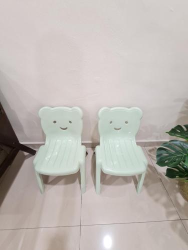 two white chairs sitting next to each other at Air-home M3 Simpang near Aulong Econsave, 4BR, 10pax, Netflix in Taiping