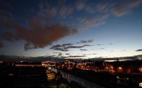 a view of a city at night at Hôtel Belvue in Brussels