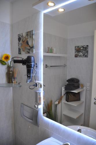 a bathroom with a mirror and a sink at TerraceOasisBerlinAirport in Schönefeld