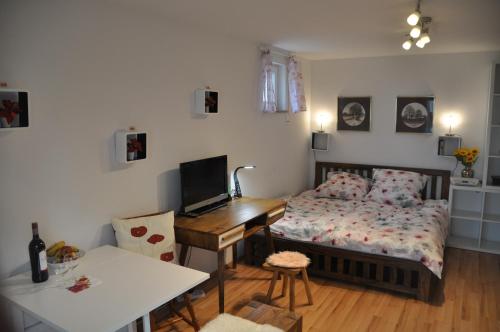 a bedroom with a bed and a desk with a computer at TerraceOasisBerlinAirport in Schönefeld