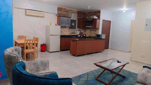a kitchen with a refrigerator and a table and chairs at Marina Delta in Al Ḩammād