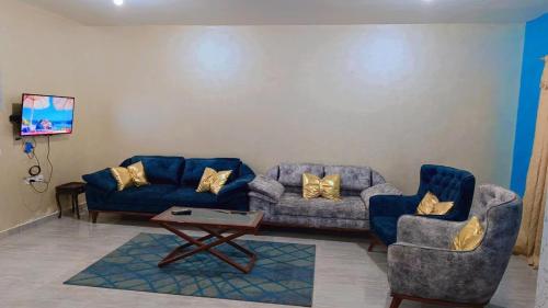 a living room with two couches and a coffee table at Marina Delta in Al Ḩammād