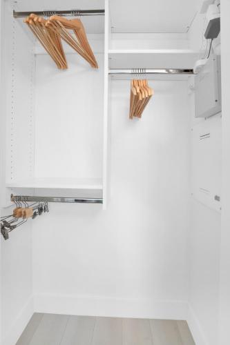 a kitchen with a white refrigerator with wooden utensils at Family-Friendly, 3 Bed House - Private Backyard-Central Location in Vancouver