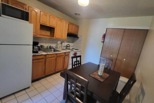 a kitchen with a table and a white refrigerator at Entire Apt in Chester 