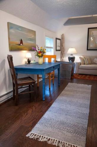 a living room with a blue table and a couch at Blue Vieira Cottage in Fennville