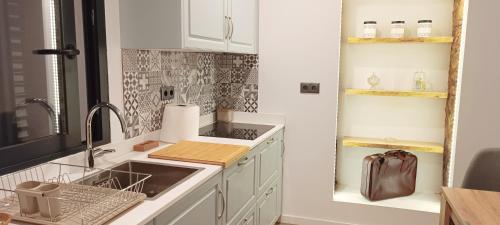a kitchen with a sink and a counter top at Faro Comfy Ensuite Guest House in Faro