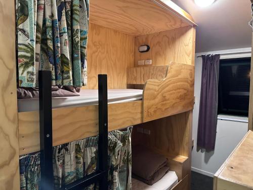 an interior view of an rv with a bed and a window at Fox Glacier Jade Hotel in Fox Glacier