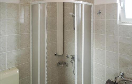 a shower with a glass door in a bathroom at 1 Bedroom Beautiful Apartment In Martinscica in Martinšćica