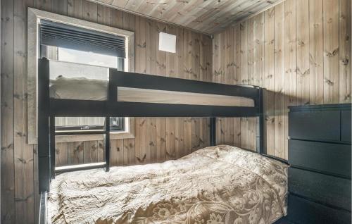 a bedroom with a bunk bed in a wooden wall at Stunning Apartment In Trysil With Sauna, Wifi And 3 Bedrooms in Trysil