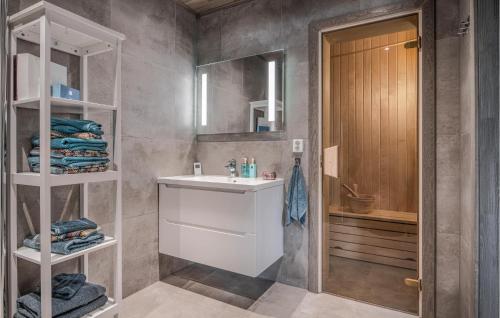 a bathroom with a sink and a mirror at Stunning Apartment In Trysil With Sauna, Wifi And 3 Bedrooms in Trysil