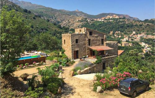 a car parked in front of a house on a mountain at Awesome Home In Ville-Di-Paraso in Ville-di-Paraso