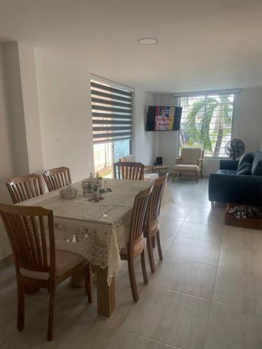 a dining room with a table and chairs and a living room at Casa Acacías - Meta in Acacías