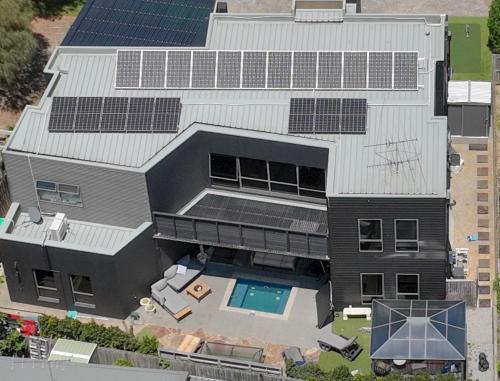 an aerial view of a house with solar panels on it at 4CHP The Sands in Torquay