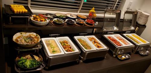 a buffet with many dishes of food on a table at Sunrise Inn Iwaki in Iwaki